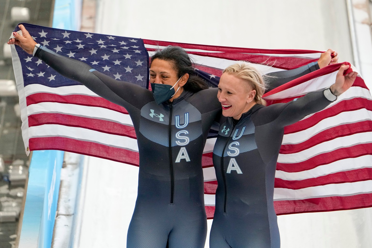 Kaillie Humphries, of the United States (r.) and teammate Elana Meyers Taylor celebrate winning the gold and silver medals in the women’s monobob.